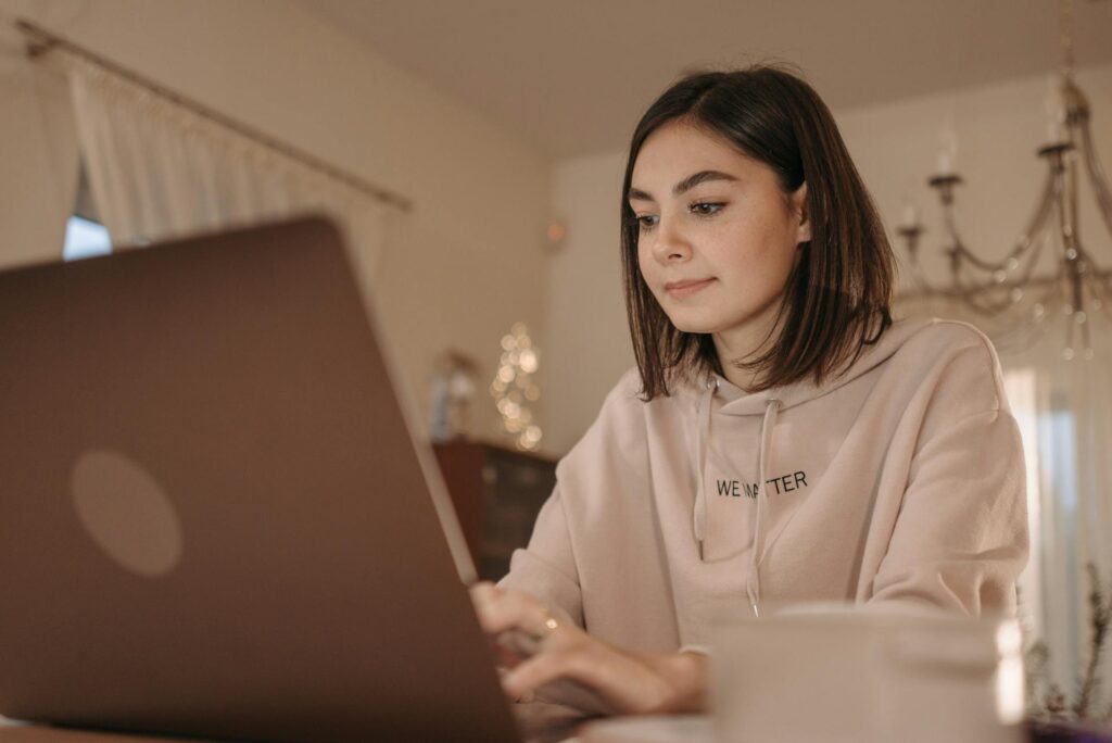 A Woman Using a Laptop in Working